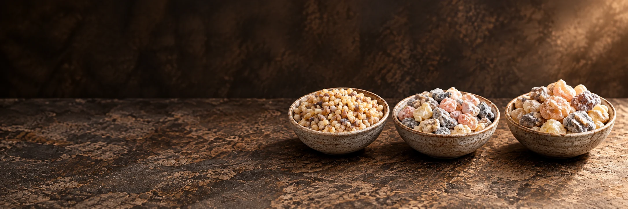 Three types of frankincense resin in rustic ceramic bowls